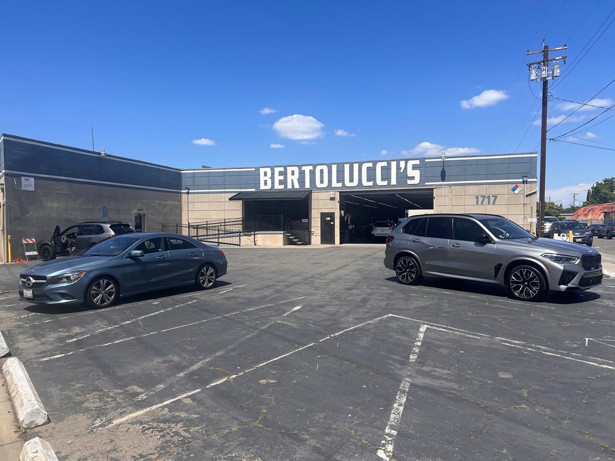 Customer parking lot in front of Bertolucci's shop entrance and service bay on Stockton Blvd