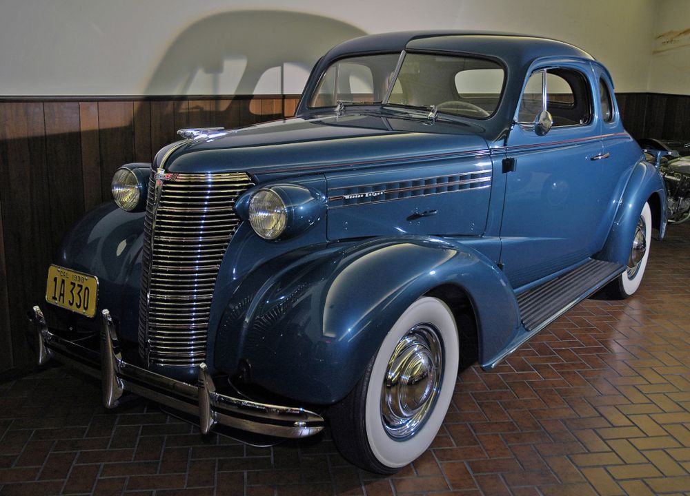 Blue 1938 Chevrolet Master Deluxe Coupe with chrome grille and whitewall tires