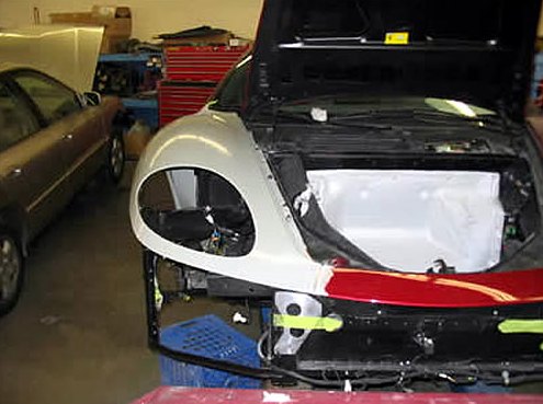 Step 3: Front of the Ferrari stripped down with the hood open, showing a new primed fender and exposed structure