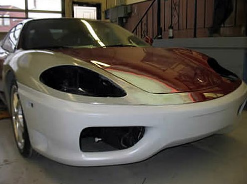 Step 7: Close view of the Ferrari's front end with a new primed bumper and fender fitted